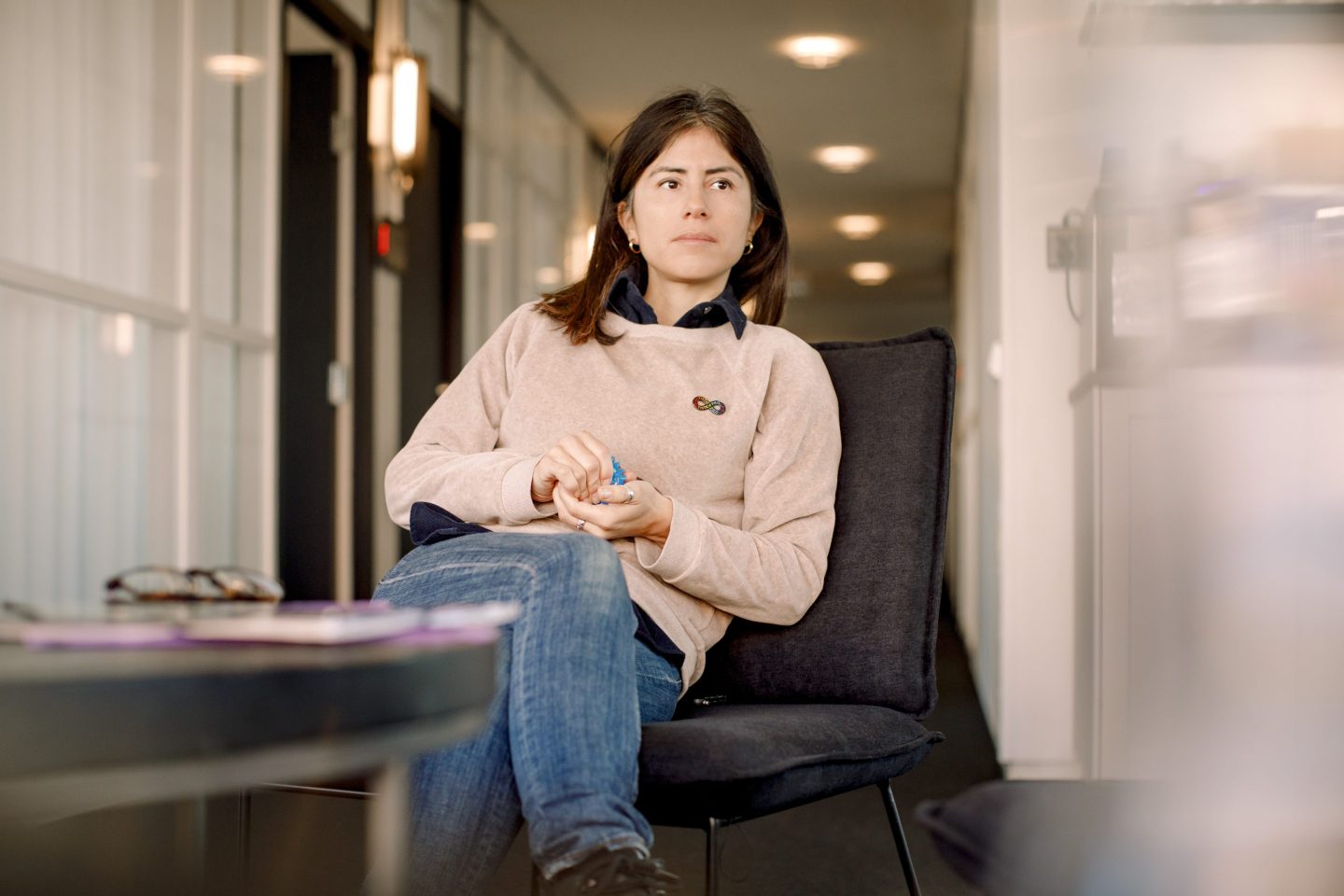 Stressed female business professional with Autism Spectrum Disorder squeezing stress ball while sitting in office